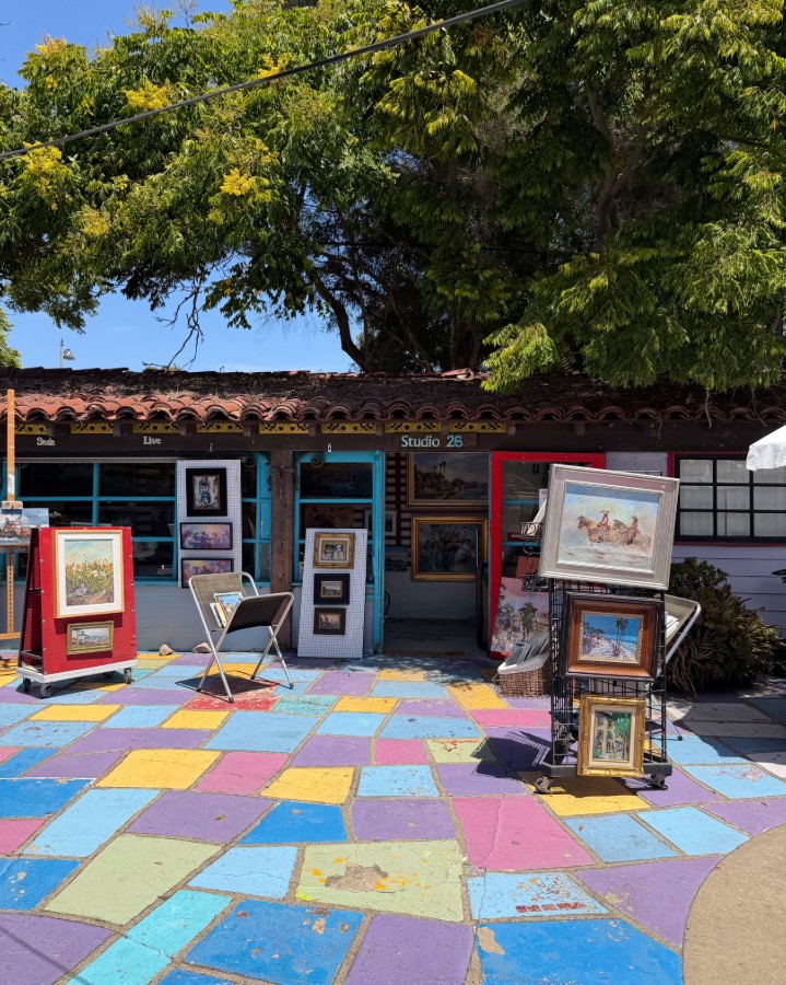 Artist working at a pottery wheel inside a Spanish Village Art Center studio cottage in Balboa Park