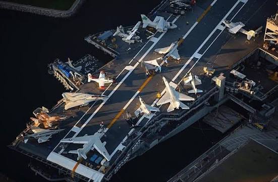 Retired fighter jets parked on the flight deck of the USS Midway Museum in San Diego Bay